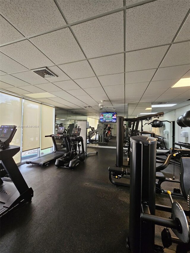 exercise room with a paneled ceiling