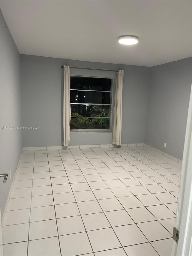 spare room with light tile patterned floors