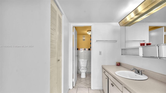 bathroom featuring tile patterned floors, vanity, and toilet