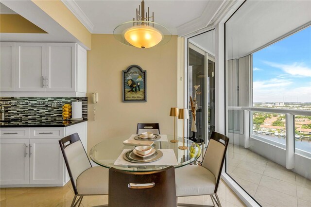 tiled dining space featuring ornamental molding