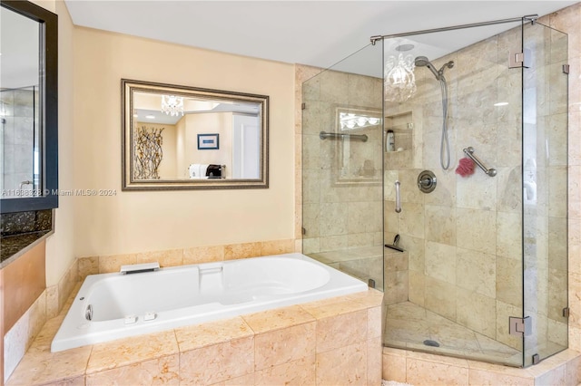 bathroom featuring shower with separate bathtub