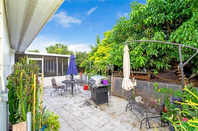 view of patio featuring a sunroom