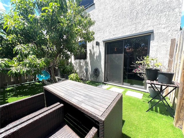 wooden terrace featuring a yard