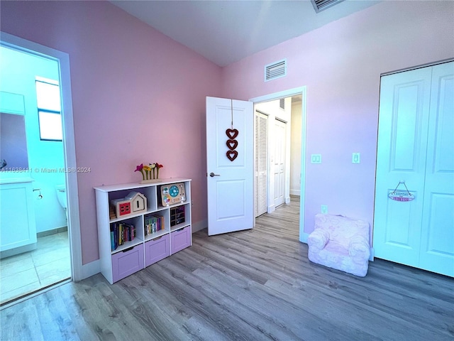 game room with light wood-type flooring