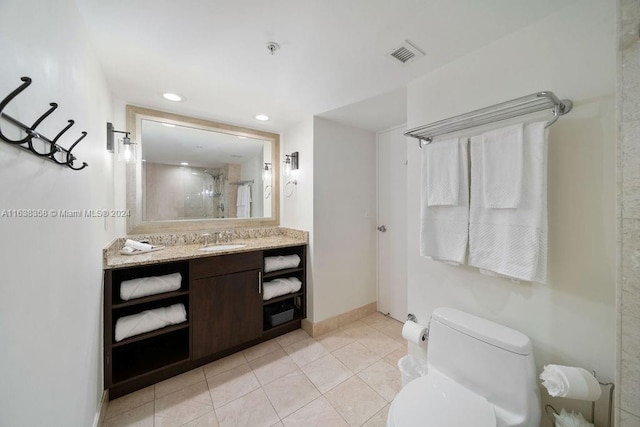 bathroom featuring tile patterned floors, vanity, and toilet