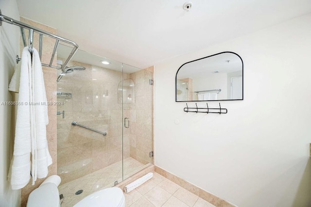 bathroom with walk in shower, tile patterned flooring, and toilet