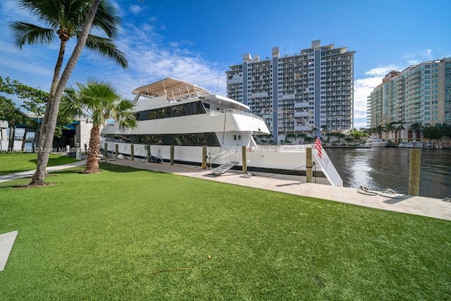 dock area featuring a water view and a lawn