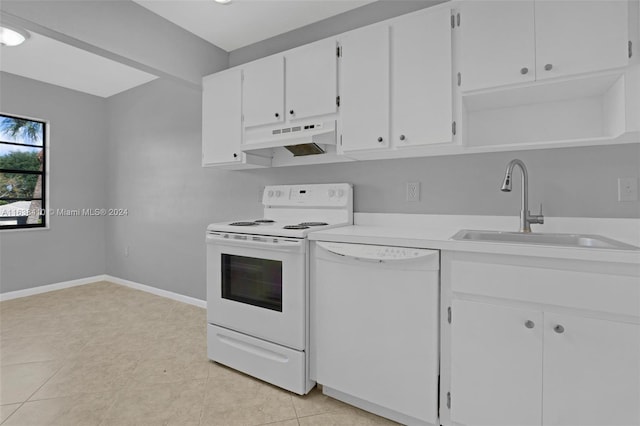 kitchen with light tile patterned flooring, sink, white appliances, and white cabinets