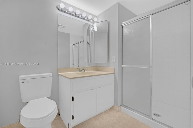 bathroom with an enclosed shower, vanity, and toilet