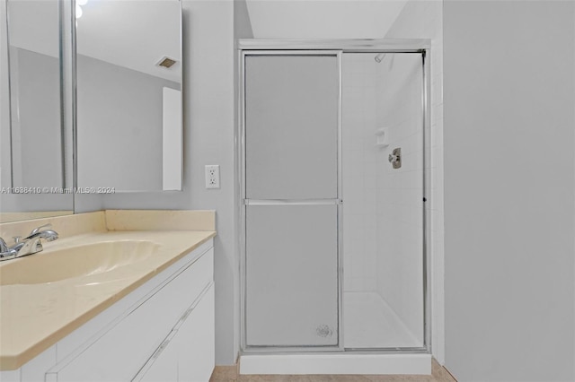 bathroom featuring vanity and an enclosed shower