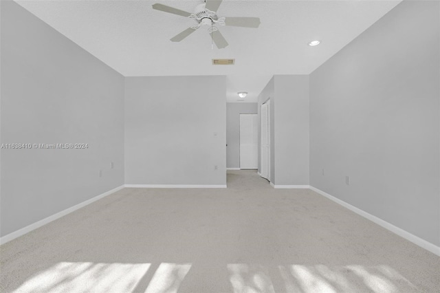 interior space featuring ceiling fan and light colored carpet