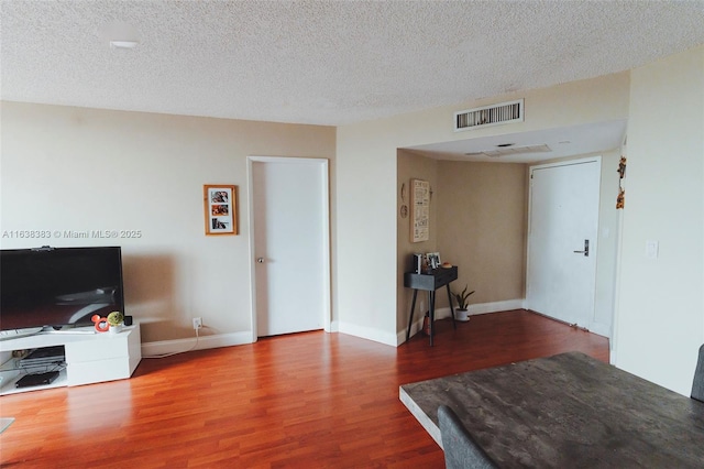 living room with hardwood / wood-style floors and a textured ceiling