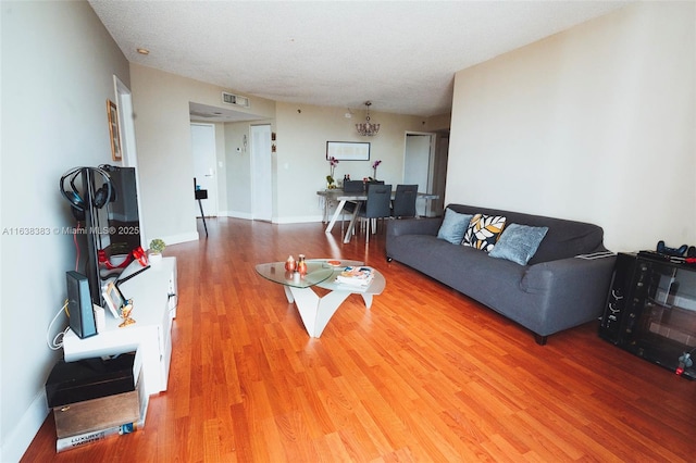 living room featuring hardwood / wood-style floors and a textured ceiling