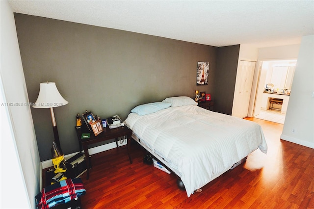 bedroom featuring dark hardwood / wood-style floors and a closet