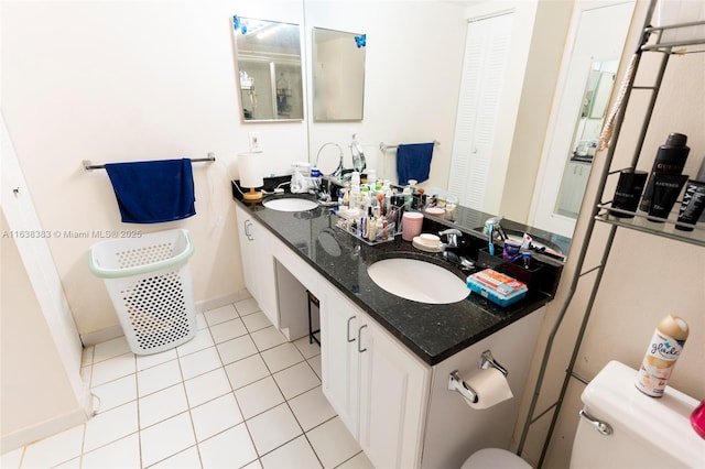 bathroom with tile patterned flooring, vanity, and toilet