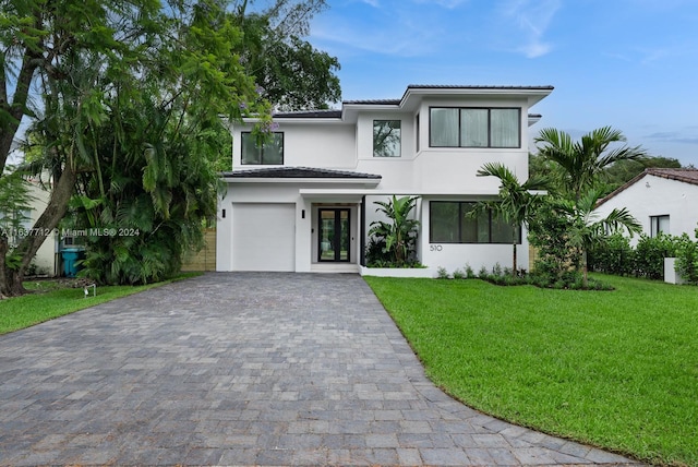 view of front of property featuring a garage and a front yard