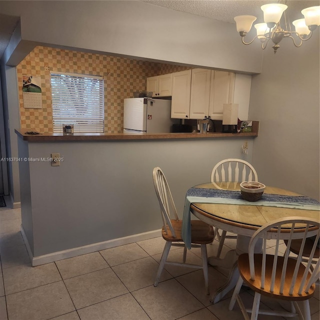 5800 NW 64th Ave Unit 108, Tamarac, FL 33319 - dining room featuring a chandelier, light tile patterned flooring, and a textured ceiling
