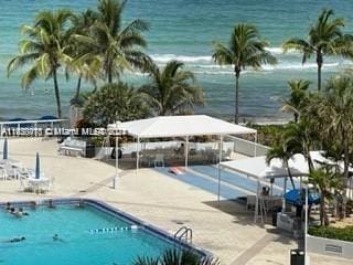 view of pool featuring a water view