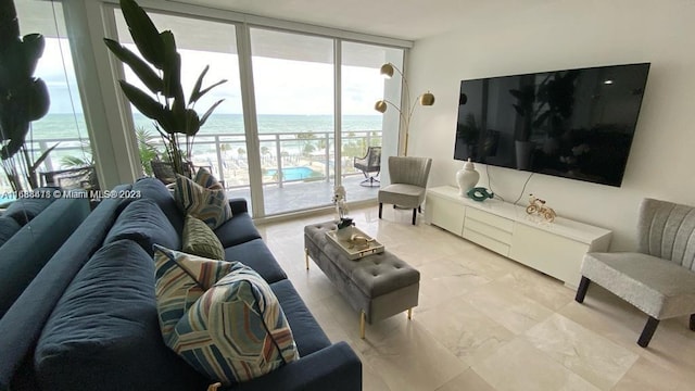 tiled living room featuring a wall of windows