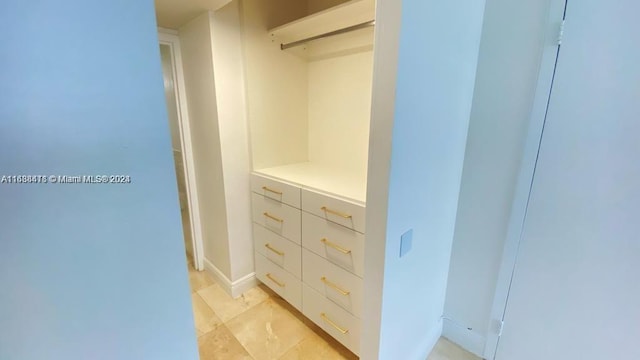 spacious closet with light tile patterned floors