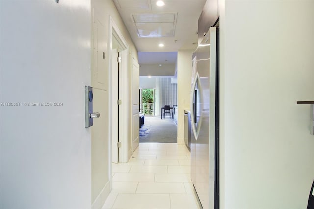 hall with light tile patterned floors