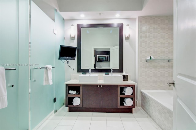 bathroom with tile patterned flooring, vanity, and separate shower and tub