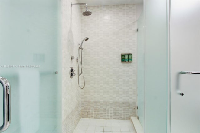 bathroom featuring a shower with door