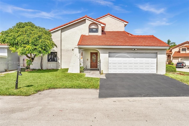 mediterranean / spanish-style home featuring a front lawn and a garage