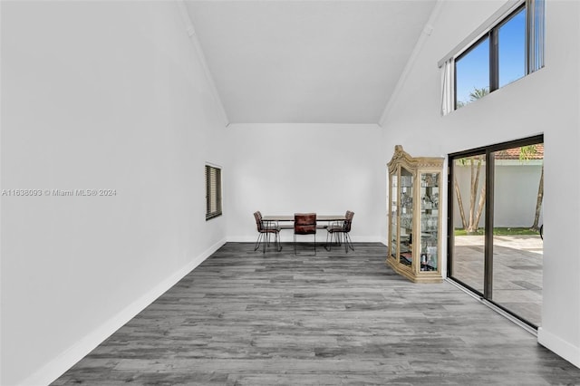 sitting room featuring crown molding, hardwood / wood-style flooring, and a high ceiling