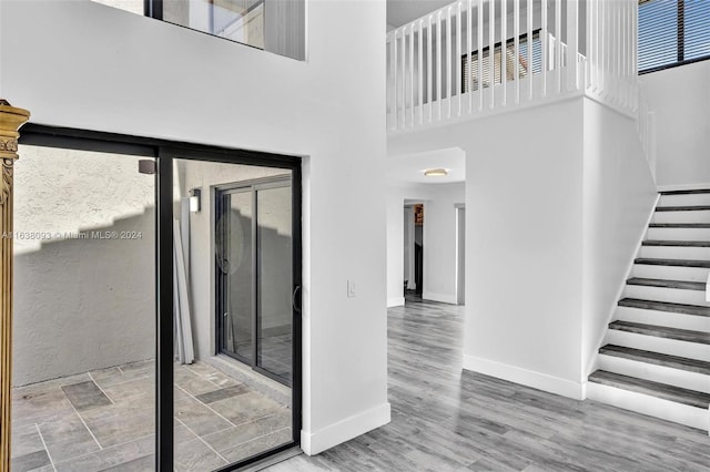 interior space with a high ceiling and hardwood / wood-style floors