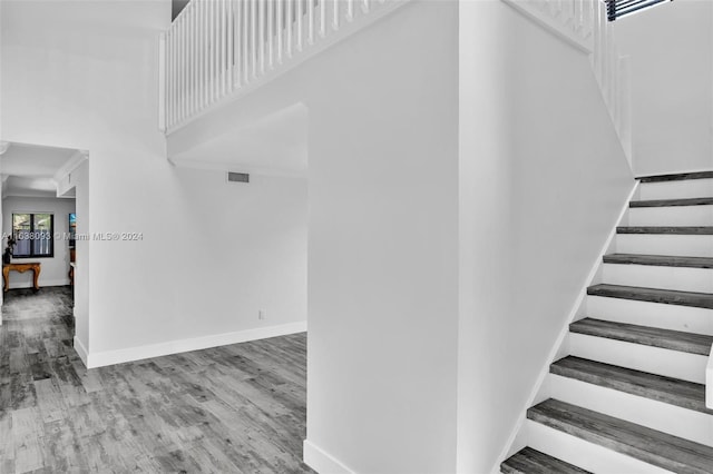 stairs with hardwood / wood-style flooring