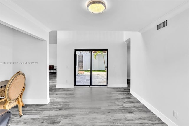 interior space with hardwood / wood-style floors and ornamental molding