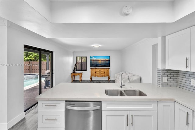 kitchen with dishwasher, white cabinetry, light hardwood / wood-style flooring, sink, and kitchen peninsula