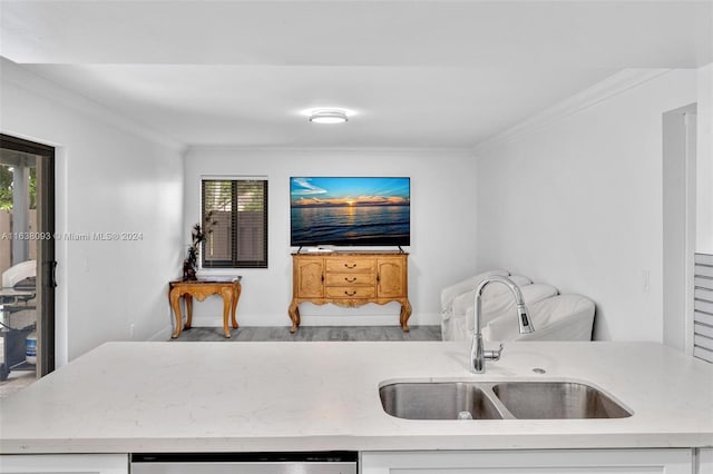 kitchen featuring sink, hardwood / wood-style flooring, light stone counters, and ornamental molding