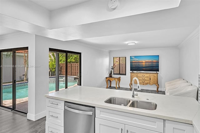 kitchen featuring hardwood / wood-style floors, sink, dishwasher, and white cabinets