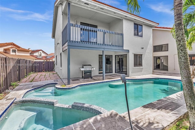 view of pool featuring area for grilling, a patio, and an in ground hot tub