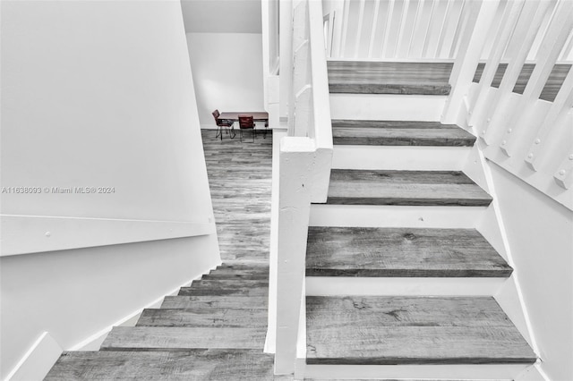 staircase featuring hardwood / wood-style floors