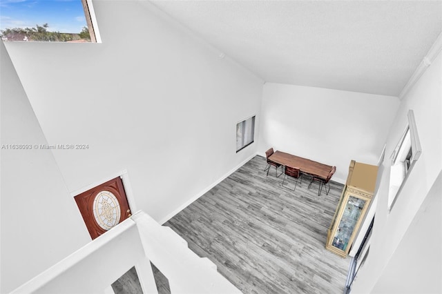 interior space featuring a textured ceiling and light hardwood / wood-style floors