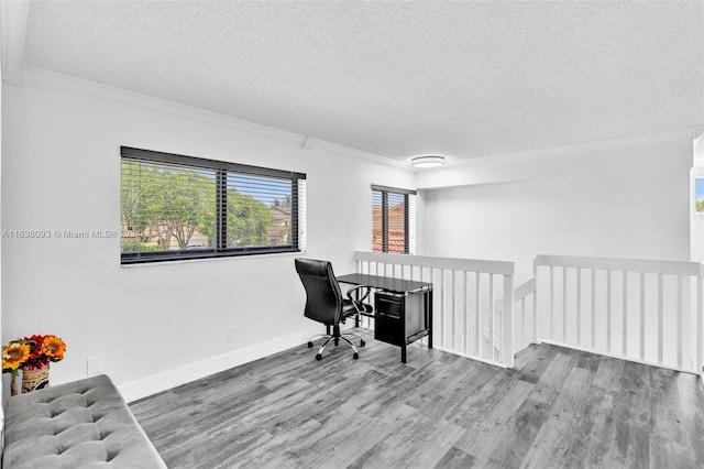 office space featuring a textured ceiling, ornamental molding, and hardwood / wood-style flooring