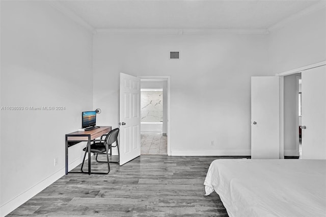 bedroom with hardwood / wood-style flooring and crown molding