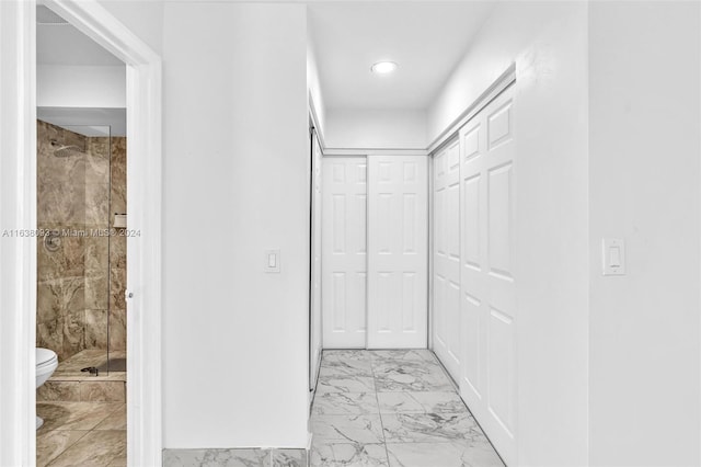 corridor featuring light tile patterned floors