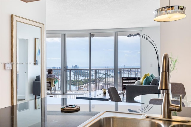 kitchen with a wealth of natural light, a city view, and a textured ceiling