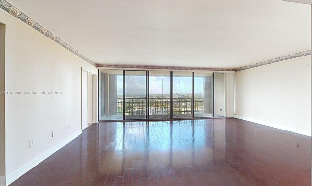 empty room with hardwood / wood-style flooring