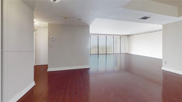 spare room with wood-type flooring