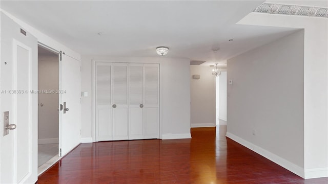 unfurnished bedroom with a closet and dark hardwood / wood-style floors