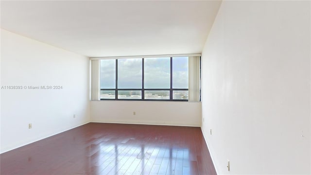 spare room featuring dark wood-type flooring