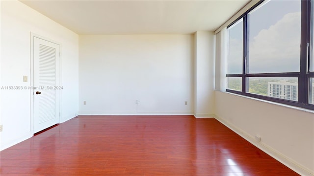 spare room with dark hardwood / wood-style flooring