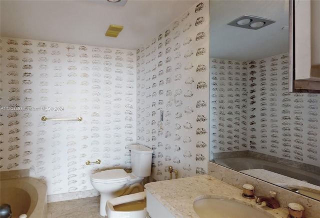 bathroom with a bidet, vanity, toilet, and a bathing tub