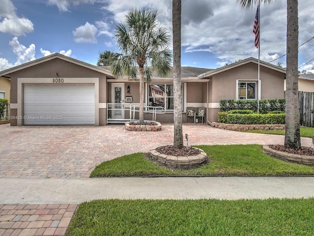 single story home with a garage, a front lawn, decorative driveway, and stucco siding