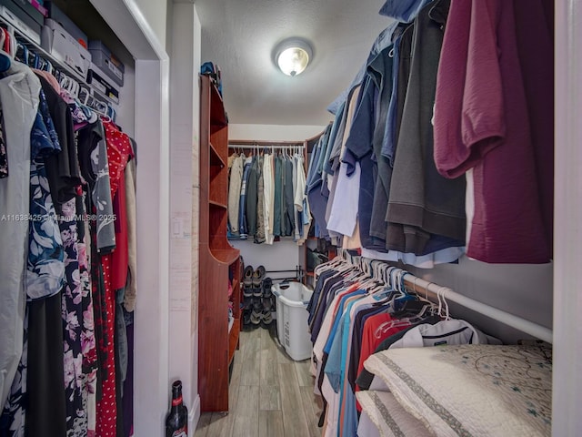 spacious closet with wood finished floors